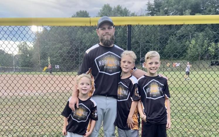 Nick Rinchich and his three sons, Cole, Tucker, and  Ashton wearing their Northlight jerseys at a softball  game last summer.
